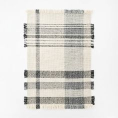 a black and white plaid blanket with fringes