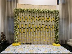 the backdrop is decorated with yellow flowers and greenery for a wedding ceremony or reception