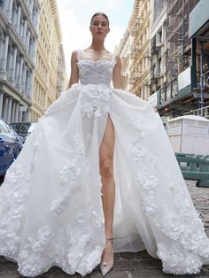 a woman in a wedding dress is walking down the street