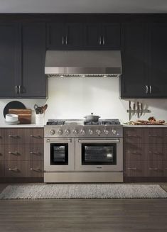 a stove top oven sitting inside of a kitchen next to wooden cabinets and counter tops