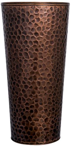 a large metal cup with holes in it