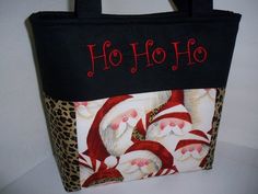 Bring it the holiday cheer and be the envy of all of your friends. This is a must have for the holiday season.This bag is made from Santa and leopard print fabric. It is sooooo cute!!Handbag is made of soft cotton fabric. It has two layers of interfacing so that is stands on it own. Also a layer of batting is added for a soft sturdy quilted feel.Bag measures approximately: 10" tall14" wide (seam to seam at top of bag)5" deepHandles are 22" in length and have a layer of interfacing for a soft stu Quilted Tote Bags Patterns, Diy Purses, Cute Handbag, Bags Sewing, Fabric Purse, Leopard Print Fabric, Leopard Fabric, Tote Bags Sewing, Quilted Tote Bags