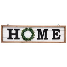 a sign that says home with a wreath on it