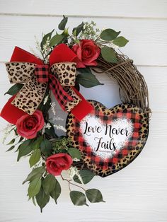 a valentine's day wreath with red roses and leopard print heart on the front