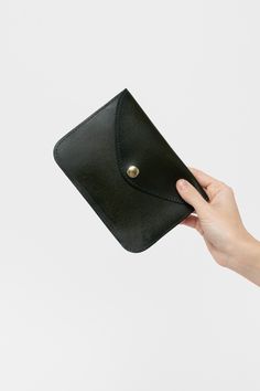 The Envelope Wallet is made of vegetable tanned leather and is secured with a steel snap. This Unisex item can be used as a simple wallet, passport holder, and even a clutch. Vegetable-tanned leather ages beautifully and is biodegradable. With proper care, this item can last for many years. It can be treated with a leather care oil to condition and clean; this process will slightly darken the leather. This artisanal product is made of genuine leather. All scars are characteristics of the skin an Everyday Rectangular Trifold Wallet With Snap Closure, Rectangular Card Holder With Snap Closure, Everyday Rectangular Card Holder With Snap Closure, Everyday Pouch Coin Purse With Snap Closure, Snap Closure Pouch Coin Purse, Everyday Snap Closure Coin Purse, Leather Envelope Coin Purse For Everyday, Everyday Bifold Bags With Snap Closure, Envelope Wallet With Coin Pocket For Everyday Use