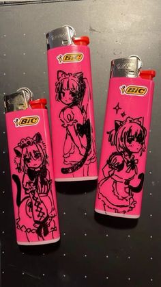 three pink lighters with black and white drawings on them