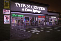 a town center at dusk with no parking signs on the front and side walk way