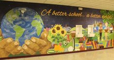 a mural on the side of a school hallway wall that says, a better school a better world