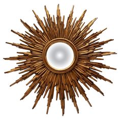 a mirror that is made out of wood and has a sunburst design on it