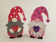 two gnomes made out of paper with hearts