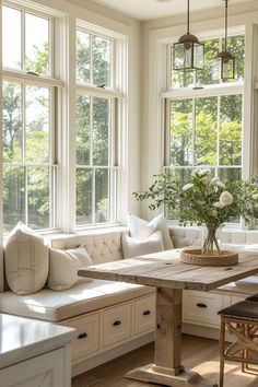 a living room filled with furniture and lots of windows