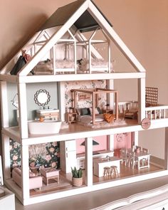 a doll house with furniture and accessories inside