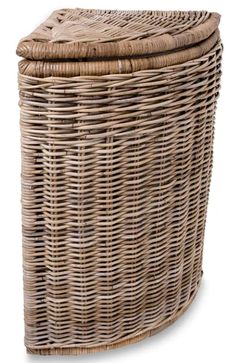 a large wicker basket with lid and handles on the bottom, in front of a white background