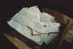 an old box filled with lots of letters and envelopes on top of each other