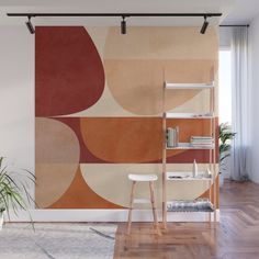 an orange and red abstract design on a wall mural in a living room with wooden flooring