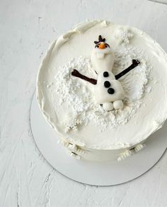 there is a frosted cake with a snowman on it