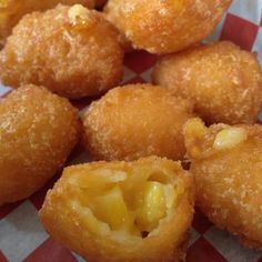 some fried food on a red and white checkered table cloth