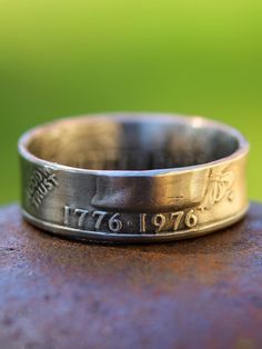 a close up of a silver ring on top of a metal object with numbers and symbols