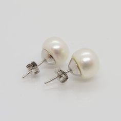 Vintage Sterling Silver White Pearl Stud Earrings ...Marked 925...Total of weights 3.5grams...Measure of Pearl 10MM...These are in very good condition. Classic White Pear-shaped Earrings, Classic Pear-shaped Hypoallergenic Earrings, Classic Hallmarked Sterling Silver Pearl Earrings, Classic Silver Pear-shaped Earrings, Classic Pierced Plug Earrings For Anniversary, Classic Sterling Silver Round Plug Earrings, Classic Round Sterling Silver Plug Earrings, Nickel-free Classic White Earrings, Classic White Nickel Free Earrings