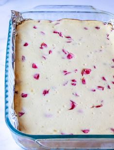 a casserole dish filled with batter and topped with rose petunia petals