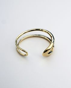 The Formation Wrist Cuff is an essential styling piece. Based on the shape of our Organic Long Hoops and wrapped into a modern wrist cuff form, this is a timeless piece that will elevate any outfit. Wear it with other styles from our core collection. DETAILS: High micron, ethically sourced 18K gold certified by LBMA Responsible Gold to meet international ethics standards. Eco brass base metal with 18K gold plating or solid 925 sterling silver. 6 months warranty Nickel free. Packaged in F+H brand