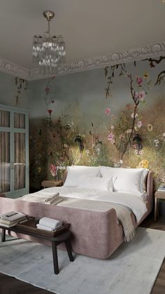 a bedroom with a large bed and floral wallpaper on the walls, along with a chandelier