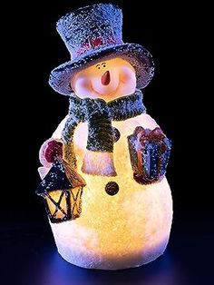 a lit up snowman with a hat and scarf