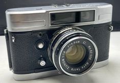 an old camera sitting on top of a table