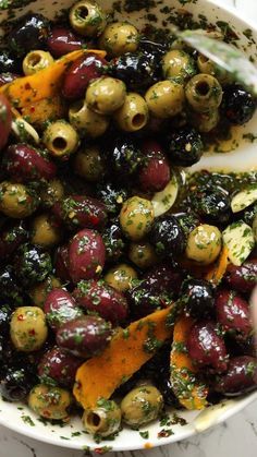 a white bowl filled with olives and other vegetables