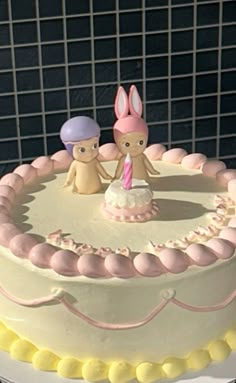 there is a cake with two bunnies on it