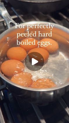 eggs are boiling in a pan on the stove and being cooked for perfectly peeled hard boiled eggs