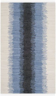 a blue and white rug with horizontal stripes on the bottom, in different shades of grey