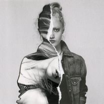 black and white photograph of a woman with torn up face, jeans jacket over her shoulders