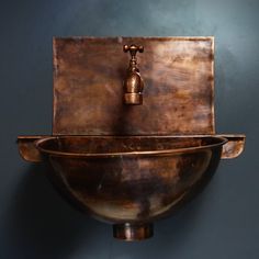 a large metal bowl with a faucet on top