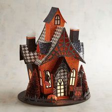 an orange and black doll house with lots of windows on it's roof is shown