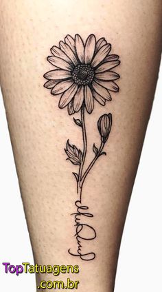 a black and white photo of a sunflower on the side of a woman's leg