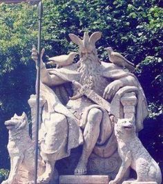 a statue of an old man sitting on a bench with two dogs in front of him