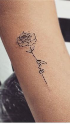 a single rose tattoo on the right side of the arm is shown in black ink