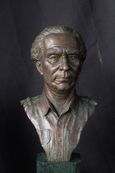 a bronze busturine of a man wearing a shirt