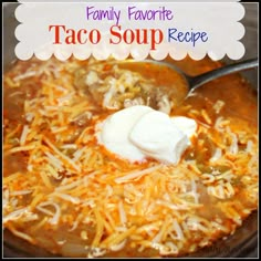 a close up of a bowl of taco soup with sour cream on the top