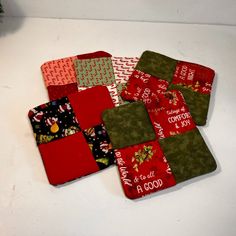 four christmas coasters on a white table