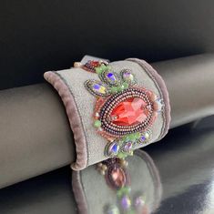 Are you looking for something charming and unique? This statement bracelet for woman can turn any outfit into something effortless chic. Bead embroidery statement cuff bracelet is embellished with top quality finest crystals, Japanese and Czech glass beads. The stunning drop shape 28x17mm pink-orange crystal in the center is surrounded with delicate Japanese seed beads and freshwater pearls. Made from soft ultrasuede, this bracelet ensures a comfortable and luxurious wearing experience, while th Handmade Bracelets For Party, Handmade Party Bracelets, Bohemian Cuff Bracelets For Party, Handmade Cuff Bracelets For Party, Handmade Cuff Bracelet For Festivals, Elegant Handmade Adjustable Wristlet, Unique Handmade Beaded Bracelets, Handmade Cuff Bracelet For Party, Unique Cuff Bracelets For Party