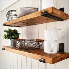 two wooden shelves with dishes and cups on them