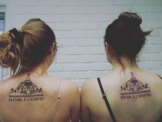 two women with tattoos on their backs