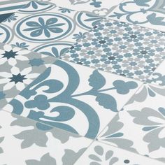 blue and white tiles are arranged together in an intricate pattern on the floor, as if they were made from ceramic tile