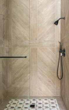 a bathroom shower with tile flooring and walls