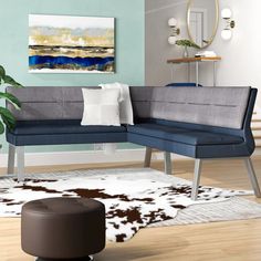 a living room scene with focus on the corner couch and cow hide rugs,