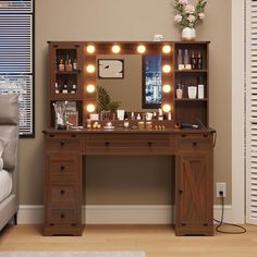 a dressing table with lights on it next to a couch