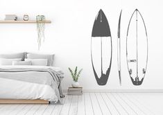 a bedroom with a surfboard wall decal next to a bed