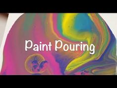 the words paint pouring are overlaided with an image of colorful swirls and bubbles